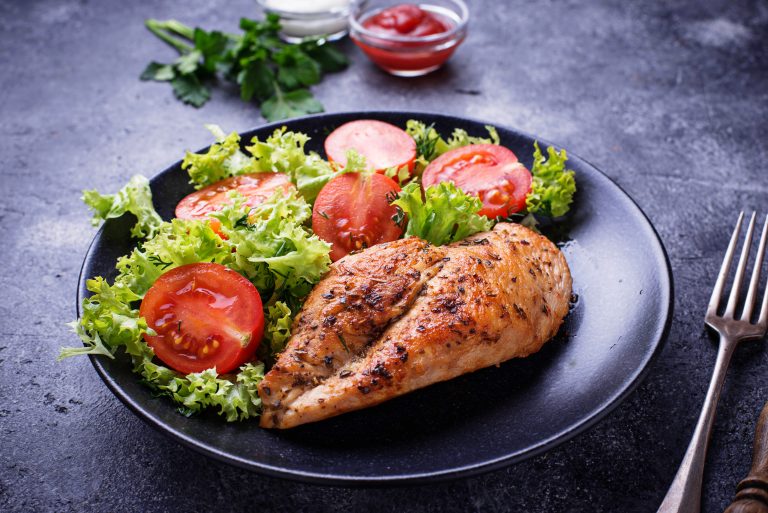 Grilled chicken breast with vegetable salad. Top view